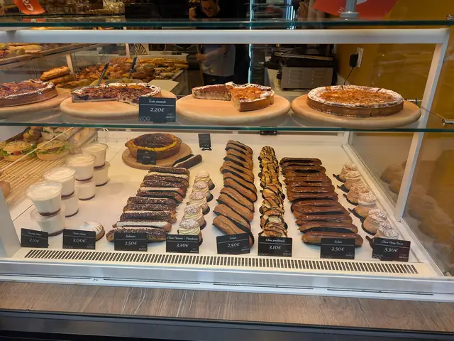 Tarts and eclairs in a patisserie display case